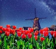 Traditional Dutch windmills from the canal in Rotterdam photo