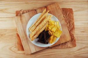 chips, crispy crackers of black bread with sesame and sticks photo