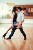 Beautiful couple of professional artists dancing passionate danc photo