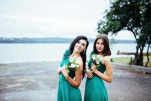 mujeres jóvenes felices en una boda con ramos de flores foto