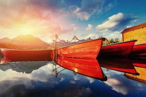 Boat on the dock surrounded mountains. Fantastic Shtrbske Pleso photo