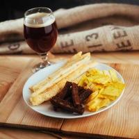 chips, crispy crackers of black bread with sesame and sticks photo