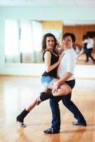 Beautiful couple of professional artists dancing passionate danc photo
