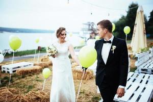 beautiful young wedding couple kissing , blonde bride with flowe photo