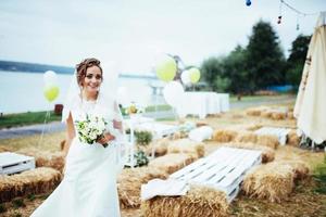 Beautiful brunette bride in a white dress at wedding photo
