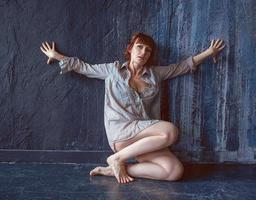 psychological emotional portrait of upset woman near the wall photo