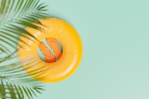 inflatable ring with flip flops inside and palm leaves photo