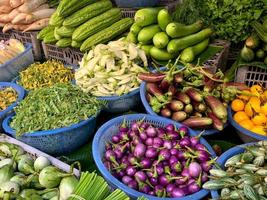 Selective focus on the colorful eggplants in the bsaket for selling in the market photo