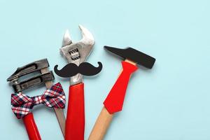 Happy Fathers Day. Top view of working tools with bow tie, false mustache and necktie. Fathers Day celebration concept photo