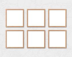 conjunto de 6 maquetas de marcos de madera cuadrados colgados en la pared. base vacía para imagen o texto. representación 3d foto