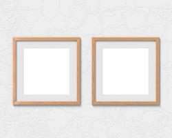 Set of 2 square wooden frames mockup with a border hanging on the wall. Empty base for picture or text. 3D rendering. photo