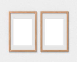 Set of 2 vertical wooden frames mockup with a border hanging on the wall. Empty base for picture or text. 3D rendering. photo