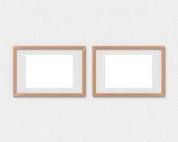 Set of 2 horizontal wooden frames mockup with a border hanging on the wall. Empty base for picture or text. 3D rendering. photo