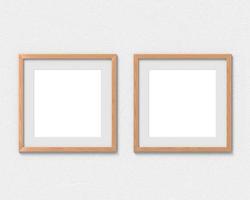 Set of 2 square wooden frames mockup with a border hanging on the wall. Empty base for picture or text. 3D rendering. photo