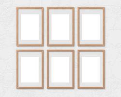 Set of 6 vertical wooden frames mockup with a border hanging on the wall. Empty base for picture or text. 3D rendering. photo