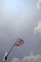 Partially torm American flag waving in the breeze photo