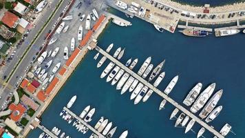 Marina. This aerial video shows yachts in the Cesme Marina with four dock lanes full of yachts and boats on the Aegean Sea, in Turkey.