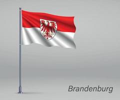 ondeando la bandera de brandeburgo - estado de alemania en el asta de la bandera. templo vector