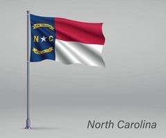 Waving flag of North Carolina - state of United States on flagpo vector