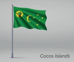 Waving flag of Cocos Islands - state of Australia on flagpole. T vector