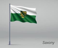 Waving flag of Saxony - state of Germany on flagpole. Template f vector