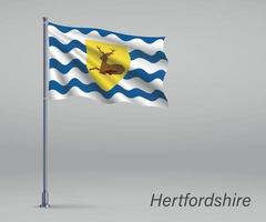 Waving flag of Hertfordshire - county of England on flagpole. Te vector