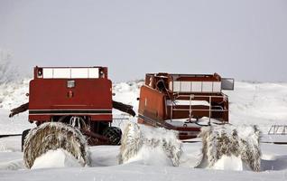 Two abandoned old combines in winter photo