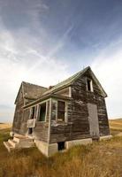 Abandoned old farm house in the Dirt Hills of Saskatchewan photo