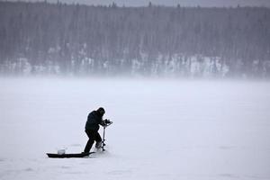 Ice fisherman on Waskesiu Lake photo