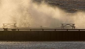 Waves crashing over pier Lake Winnipeg Manitoba photo