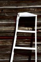 Aluminum ladder against old garage in Saskatchewan photo