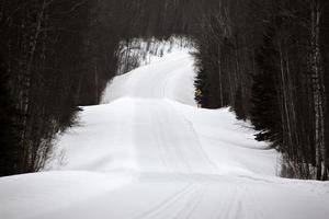 Snow covered road in winter photo