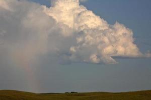 Thunderhead forming with a rainbow in the Missouri Coteau photo