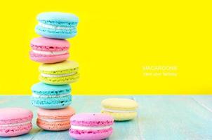 French macaron cookies on bright yellow background.Sweet dessert. photo