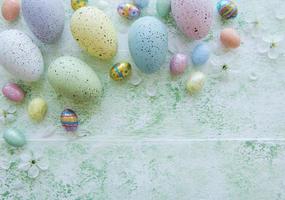 Colorful Easter eggs on green wooden background photo