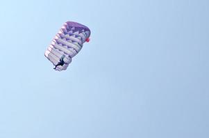 A parachute over a blue sky background photo