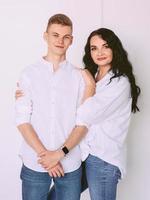 brunette beautiful stylish woman with teen son in white shirts and jeans. Family, style, relative concept photo