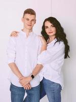 morena hermosa mujer elegante con hijo adolescente en camisas blancas y jeans. familia, estilo, concepto relativo foto