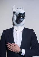 man with a horse mask on a light background photo