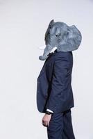 man with an elephant mask on a light background photo