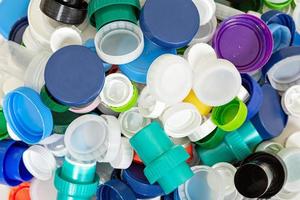 Pile of various plastic lids photo