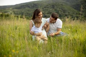 Young family having fun outdoors in the field photo