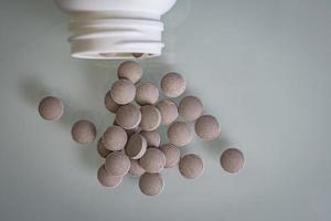 pills are scattered on the table. treatment or suicide photo