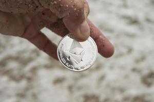 ethereum Cryptocurrency. e-currency. sea. ethereum in hand photo