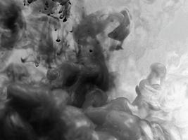 Close-up view of group of white smoke or steam spray from a humidifier. Isolated on black background.Space for copying idea text The feeling of intense air danced .storm black and white clouds photo