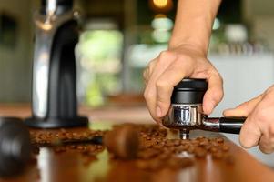 The barista preparing various tools to make espresso. photo