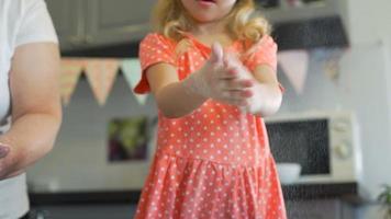 Little Girl Clapping her Hands to Clear it from Flour video