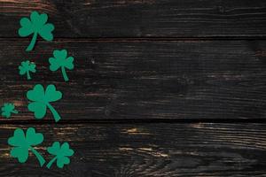 Concept for St. Patrick's Day. Shamrock on a dark wooden background. photo