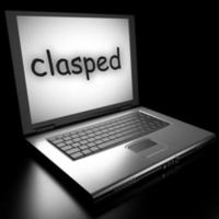 clasped word on laptop photo