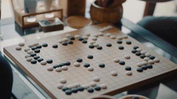 Close up view of hands young people playing go board game in living room video